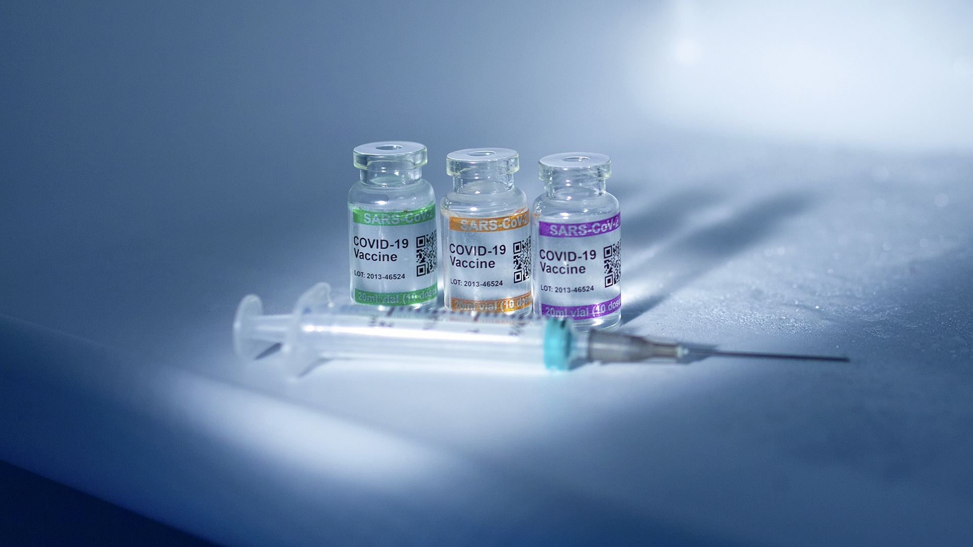 Refrigerator compartment storing COVID-19 Vaccine vials at low temperature with syringe. Labeled SARS-CoV-2 against Coronavirus