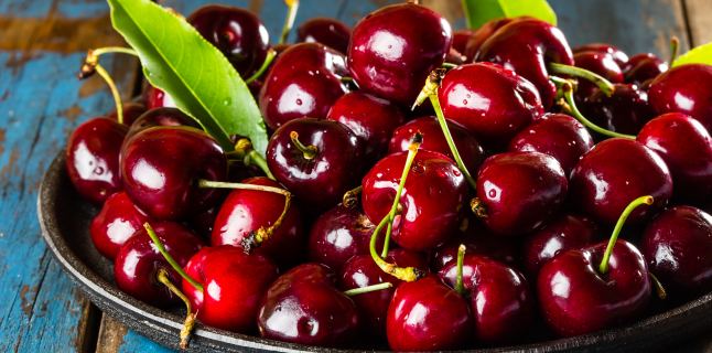 Fresh cherry on black plate